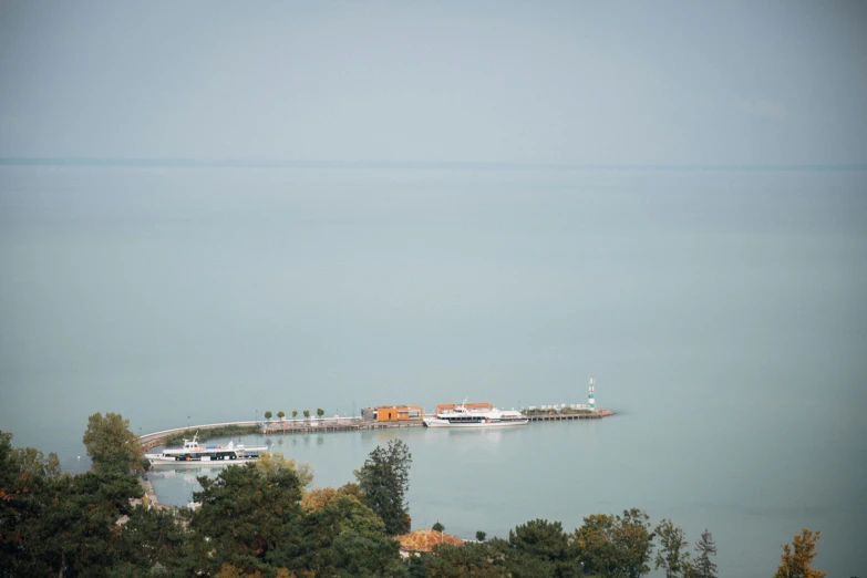 the view from above a boat dock surrounded by trees