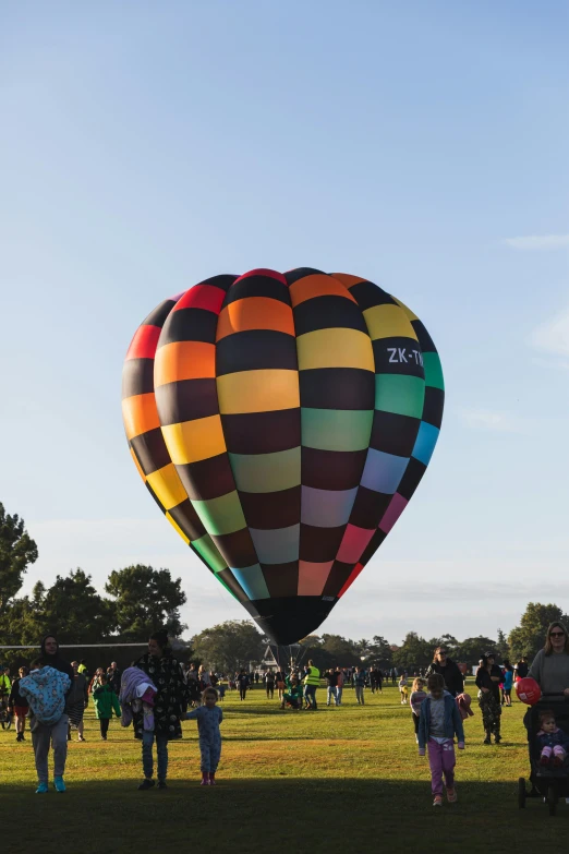 a large colorful air balloon is flying in the sky