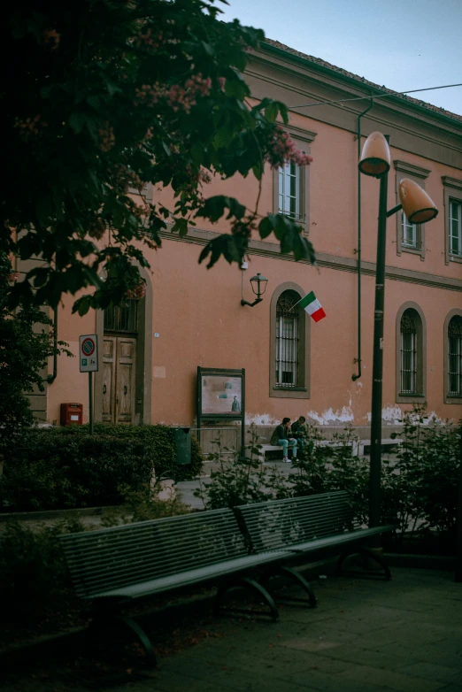 an old building with a bunch of windows and a lot of trees