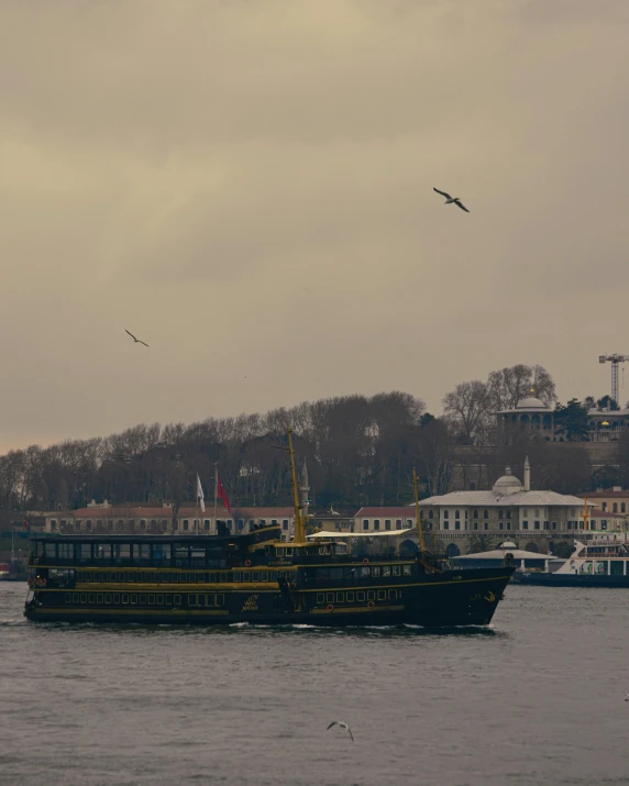 two ships at sea in front of a city skyline