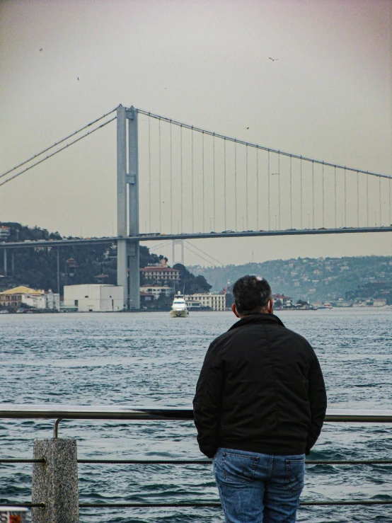 man looking at view of the bay bridge