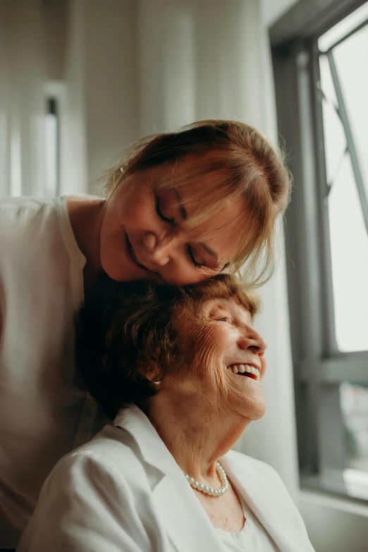 the woman is holding the lady with one arm on her neck