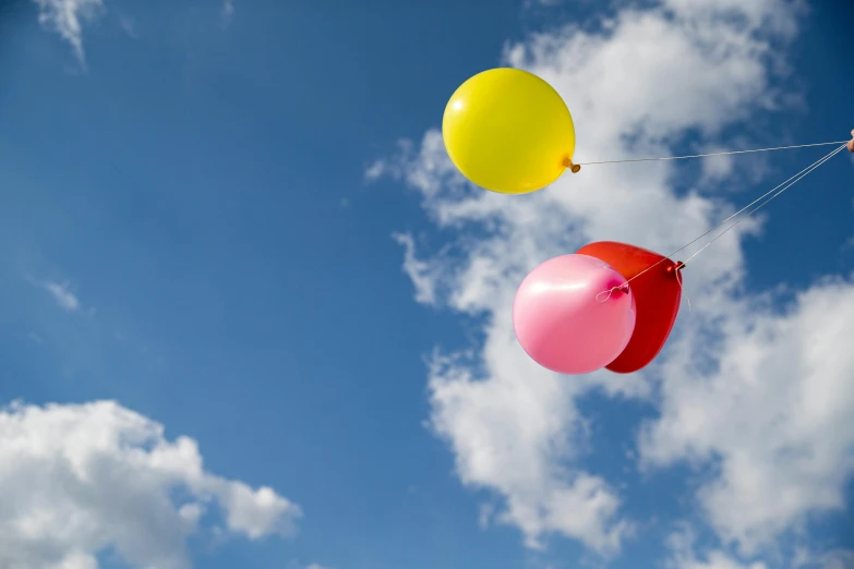 several colorful balloons are being flown in the air