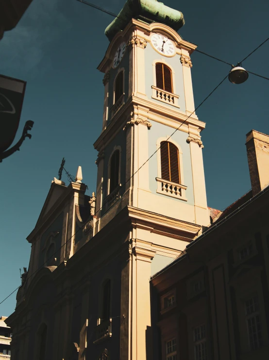 an architectural building has a clock on the front and sides