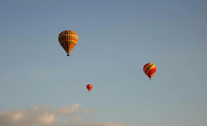 three  air balloons flying in the sky