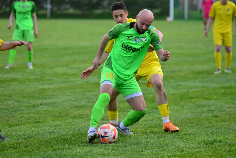 the two soccer players fight for the ball