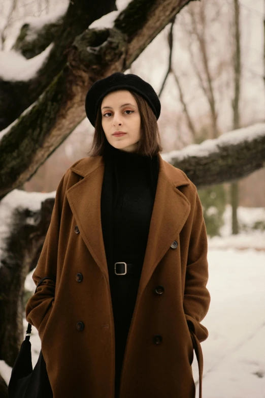 woman wearing brown coat and black top under tree