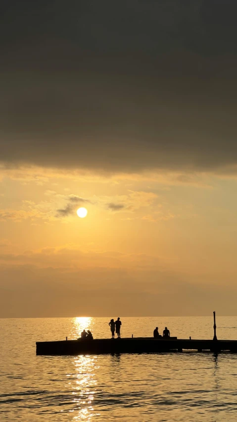 three people are rowing in a small boat