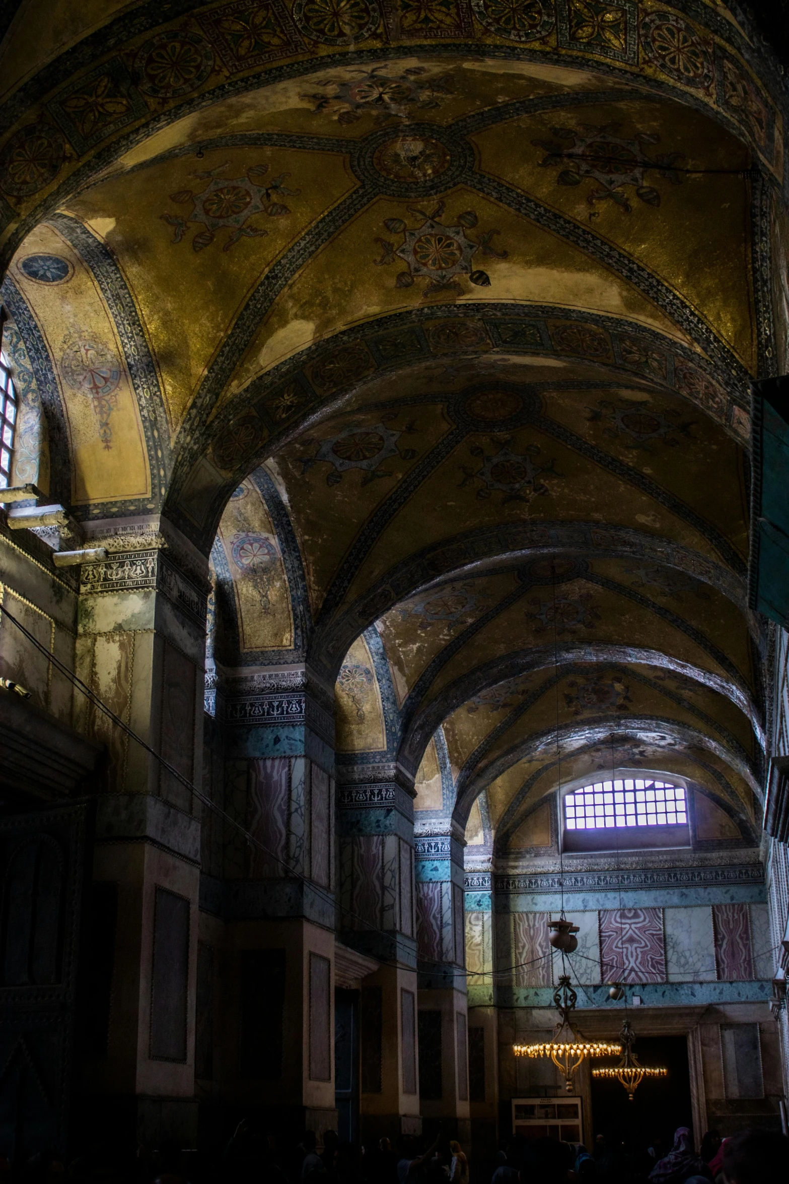 a dimly lit room with very large arched ceilings