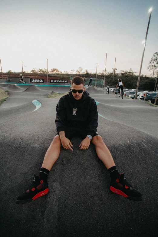 a person sitting on the road with their foot in the air