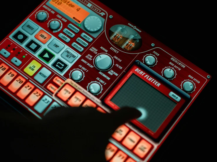 a hand clicking on an analog music mixer
