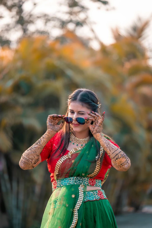 a woman in an indian outfit talks on her cell phone