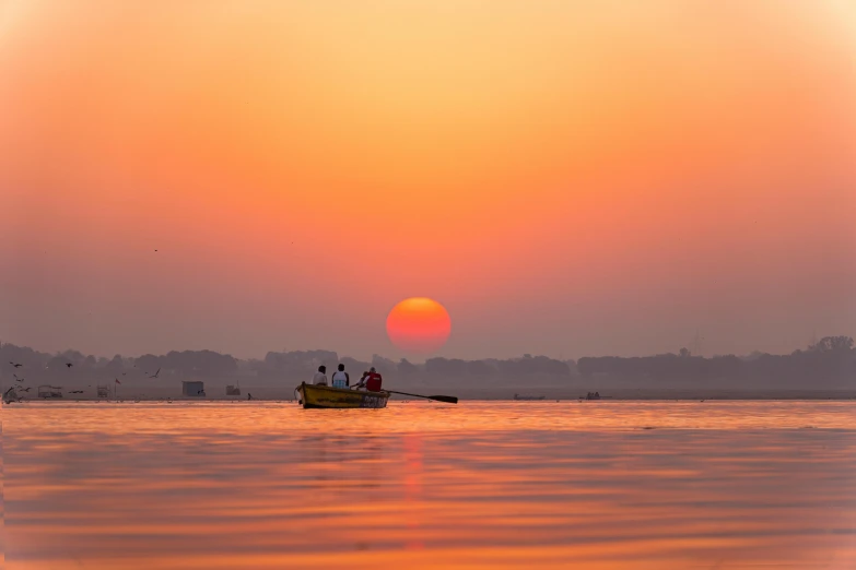 some people are sailing a small boat on a large body of water