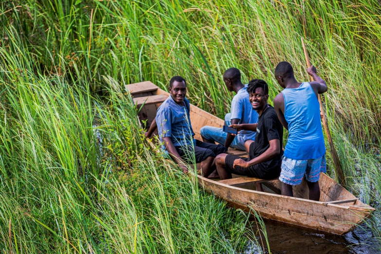 five men in a boat on the water