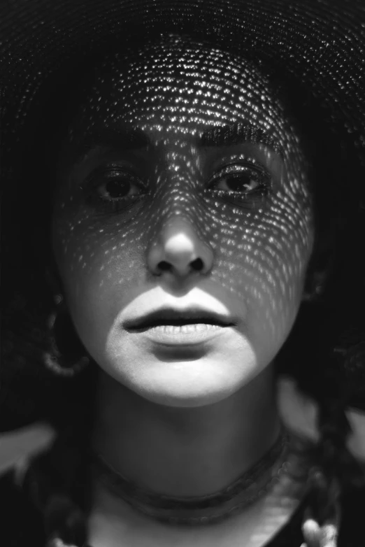 a black and white image of a woman with a hat