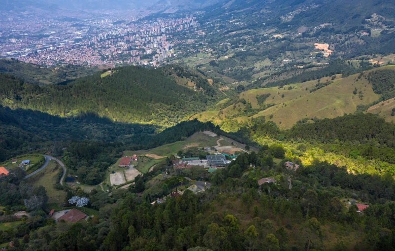 a scenic view of mountains and green hills in the distance