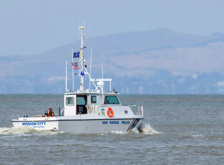 a small boat with passengers in the ocean