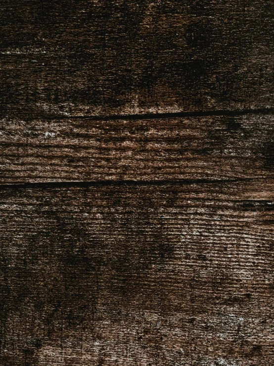an old worn, brown surface shows wood like grain