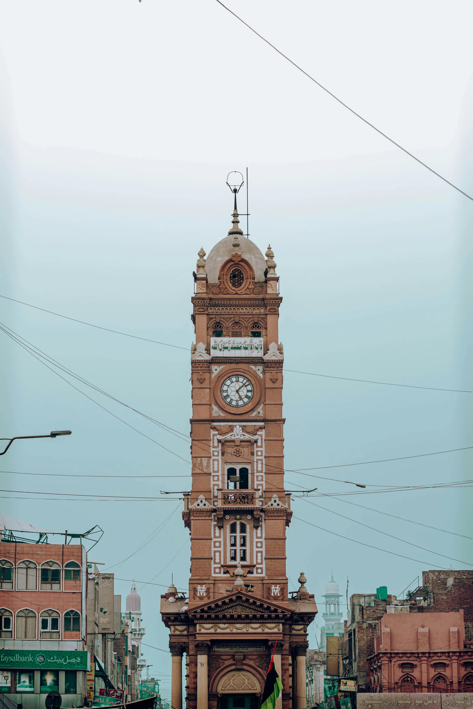 an old brick clock tower on a town square