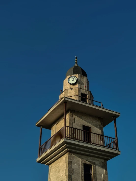 a clock tower that has a railing on the top