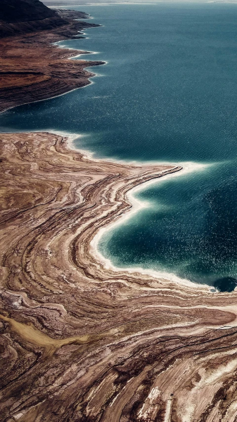 a big body of water with rocks and sand in it