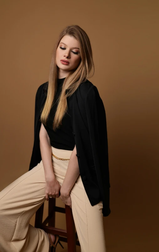 a woman in an outfit sitting on a stool