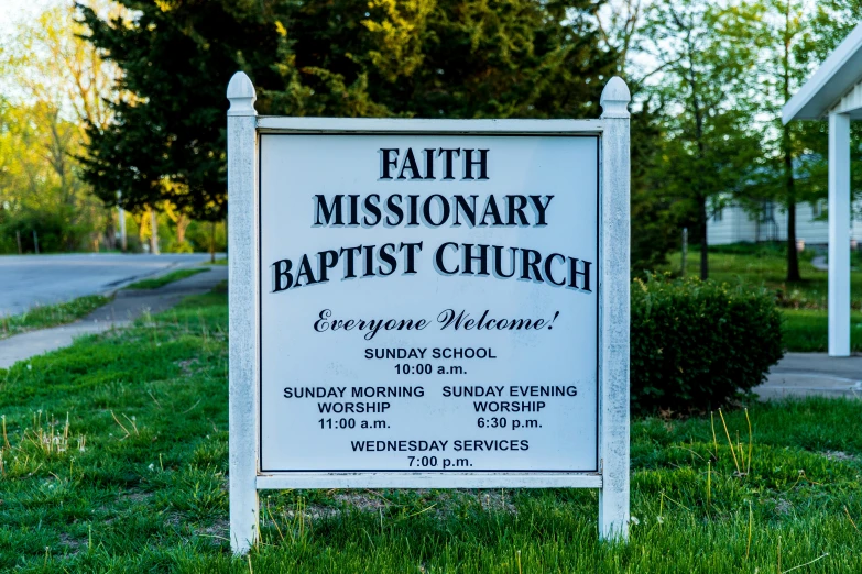 a sign advertising the baptist church for the first time