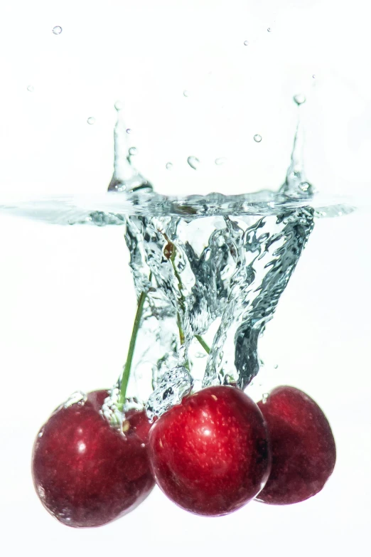 four cherries are placed on the surface of water