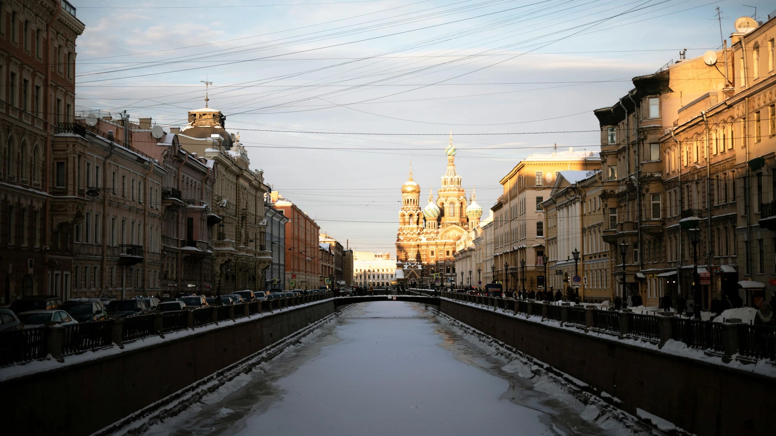 an empty waterway is surrounded by buildings and telephone lines