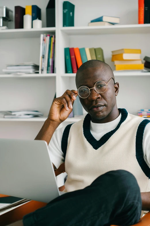 an african american man working on a laptop in his home office