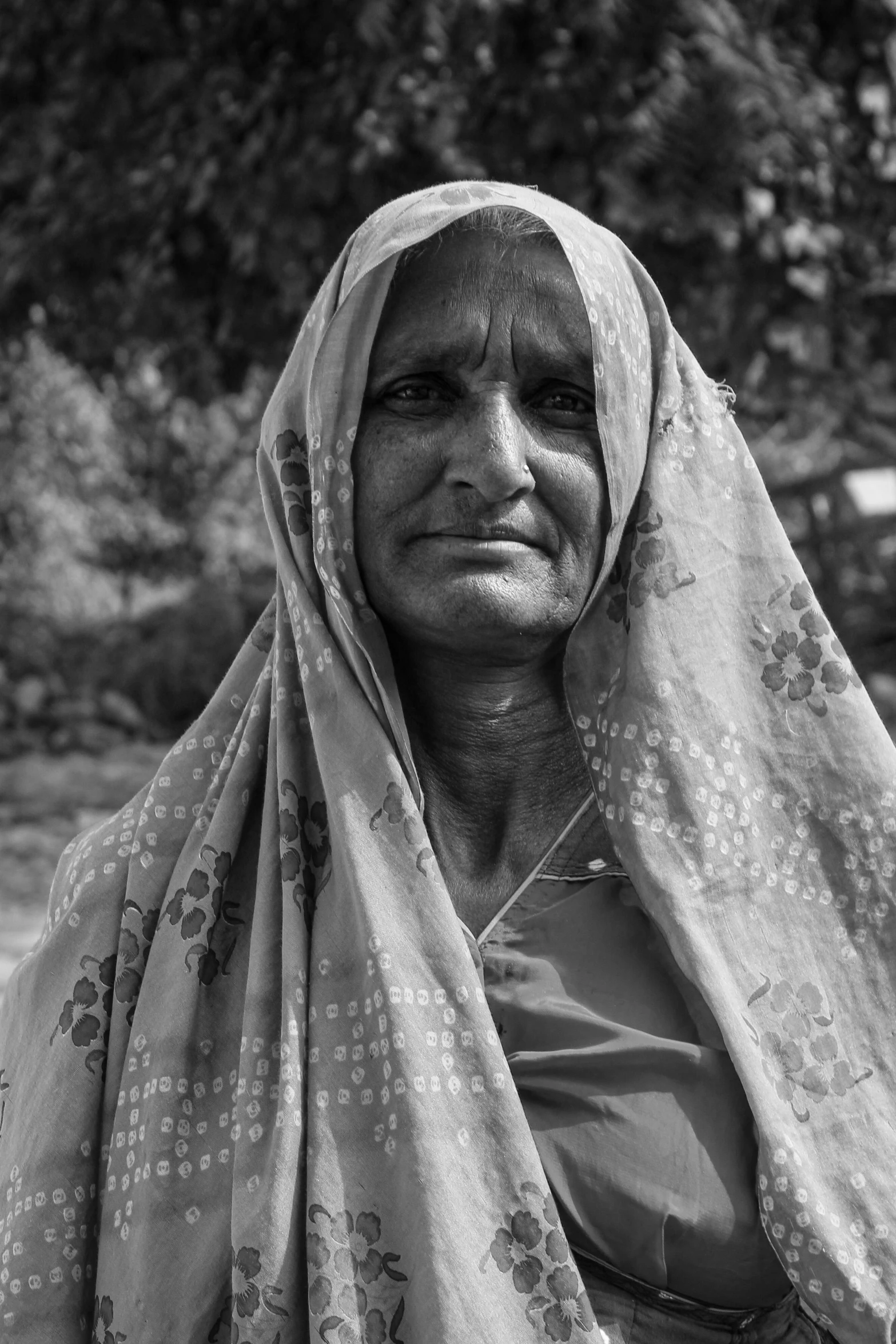 a woman with a headscarf looking at the camera