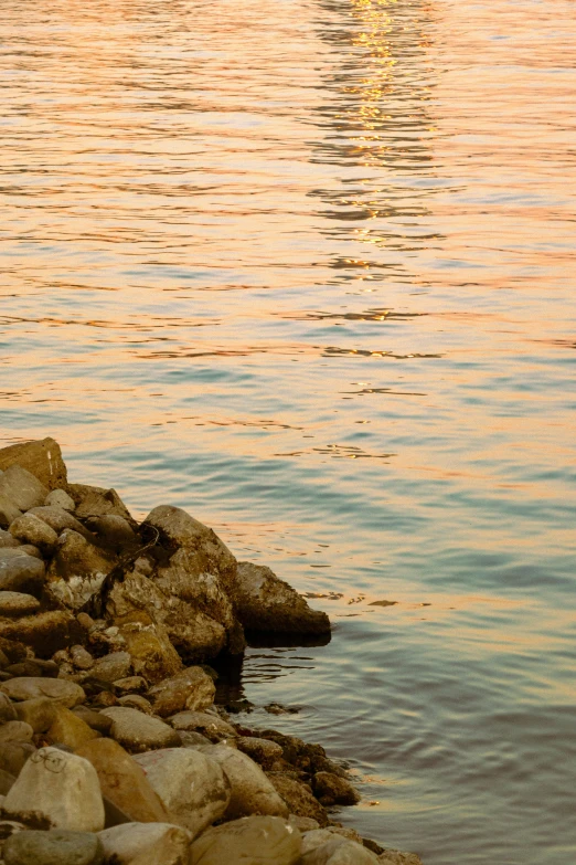 a sailboat out on the water near rocks