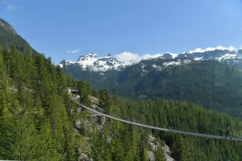 a suspended walkway in the mountains, which is a long pedestrian path