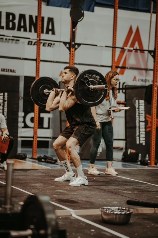 a man is standing with a large barbell