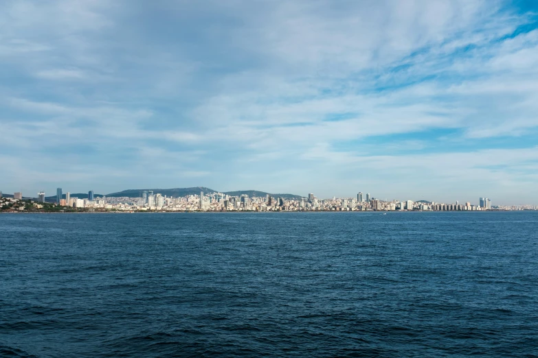 a large body of water that has a city in the distance