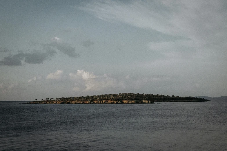 a large body of water with small island in the background