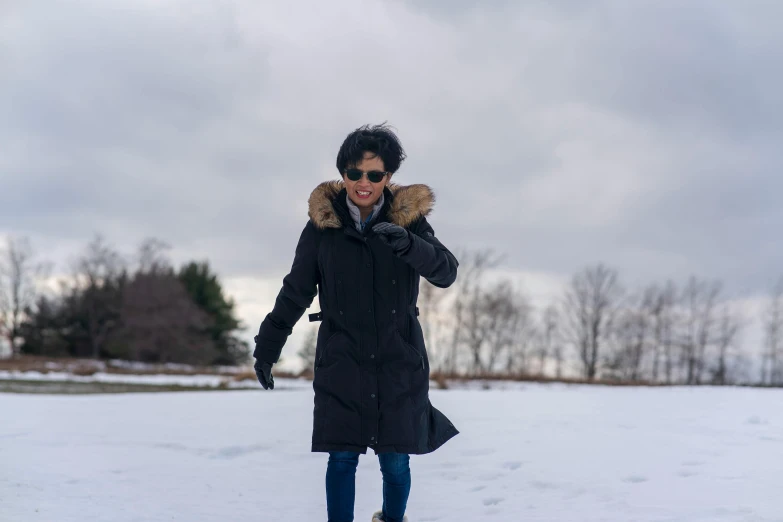 the woman wears an animal - ear hat while walking in the snow