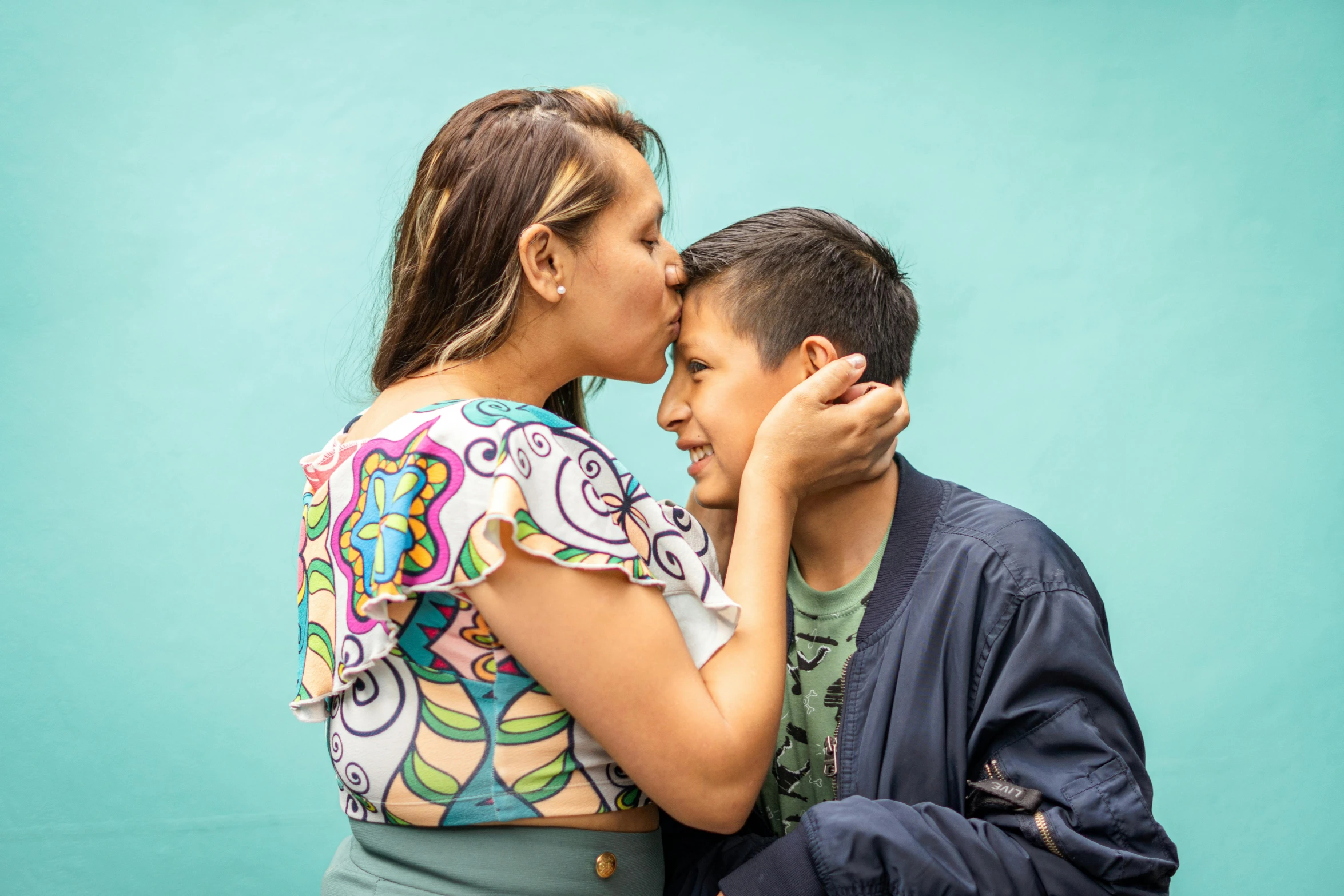 a man is kissing a woman on the cheek