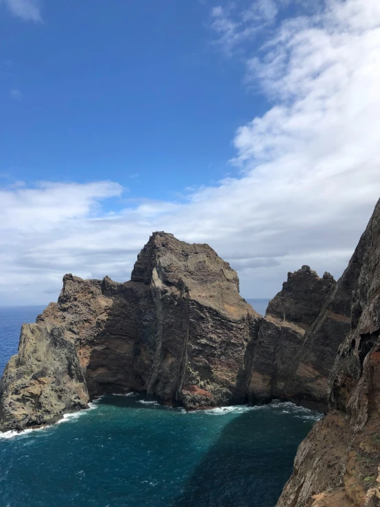 an island with some large rocks next to a body of water