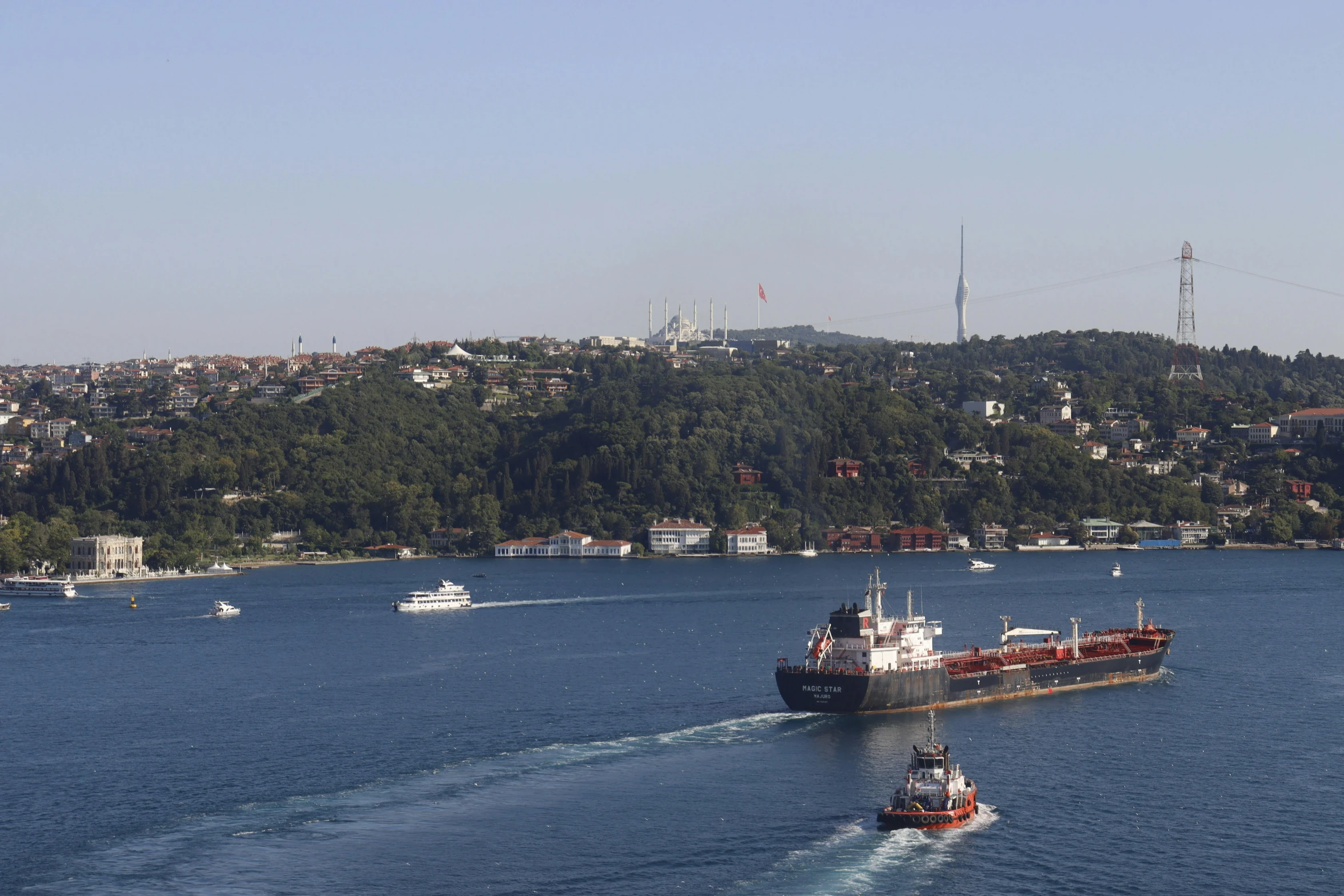 a large cargo ship passing by a barge