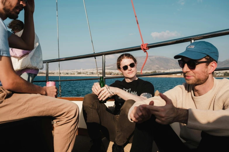 two men and one woman sitting at the end of a boat