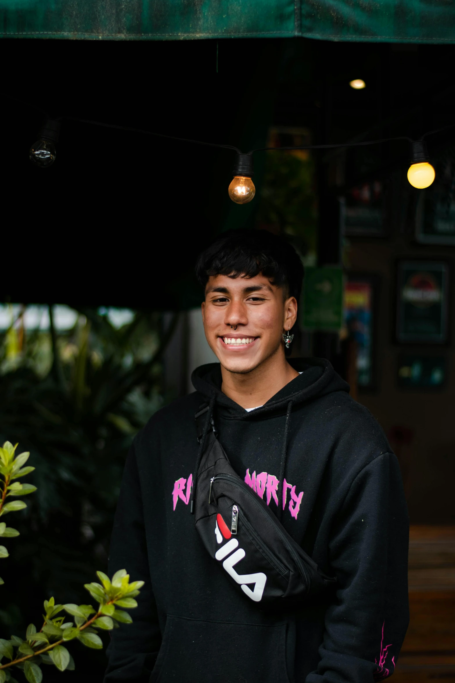 the boy is posing for the camera outside the cafe