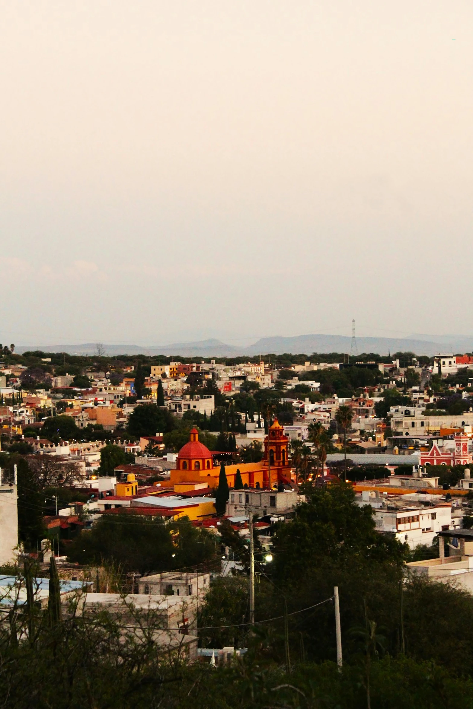 the view of a city from the hill in mexico