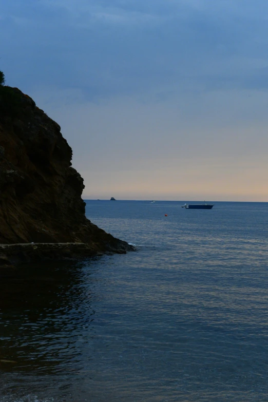 a large boat out on the open water at sunset