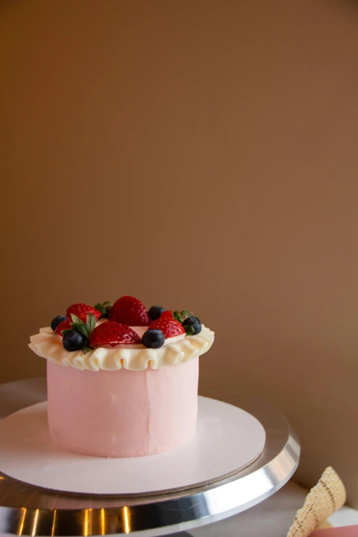 a cake on a table with a white plate with a silver plate holding it