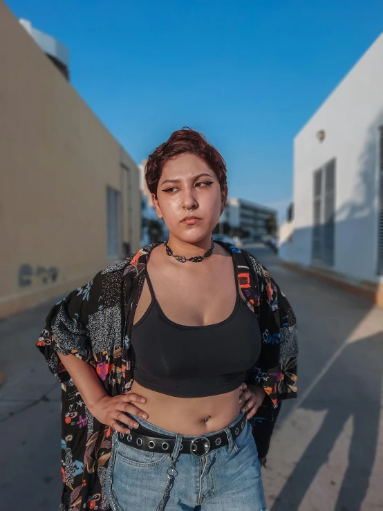 a beautiful woman standing next to a building