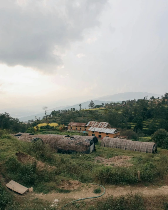 a mountain side house that is covered in grass