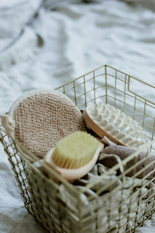 a basket that contains bath items, including a brush and soap