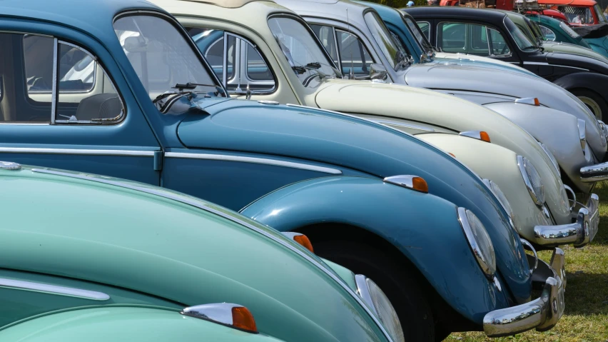 row of various colored cars parked in a lot