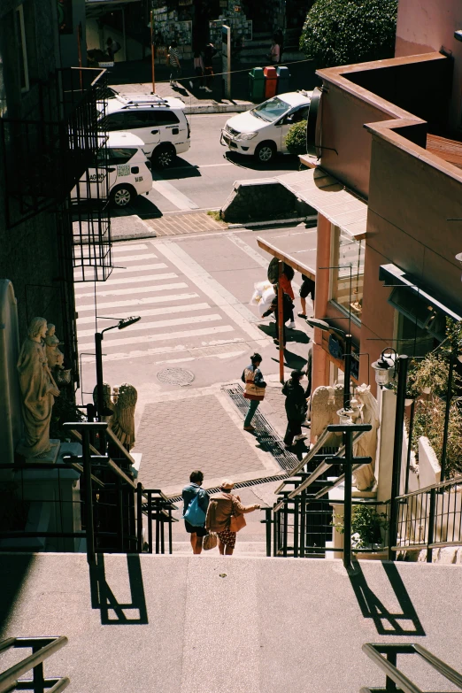 two children walking up stairs on an apartment building